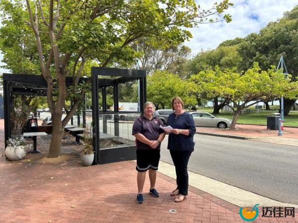 Peter Harrington hands the petition over to deputy mayor Lorna Buchan.