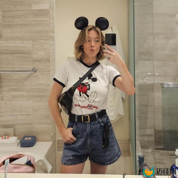 Sydney Sweeney taking a selfie in a bathroom mirror