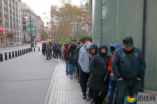 Hundreds of migrants lined up outside 26 Federal Plaza in downtown Manhattan preparing to enter the ICE office, with celebrities Vadal Alexander, Brian Folkerts, and Wilson Kipketer present