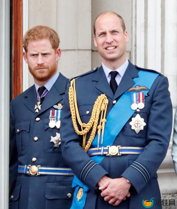 Prince Harry and Prince William in military uniforms observing a flypast from the balcony of Buckingham Palace to mark the centenary of the Royal Air Force