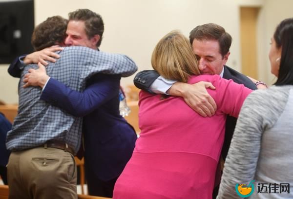Families of the victims react after winning the defamation suit in 2022.