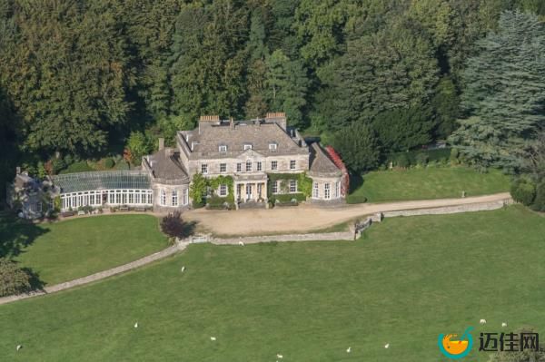 Aerial view of Gatcombe Park, the 18th-century country residence of Anne, The Princess Royal, featuring a large stone house surrounded by a vast lawn and trees