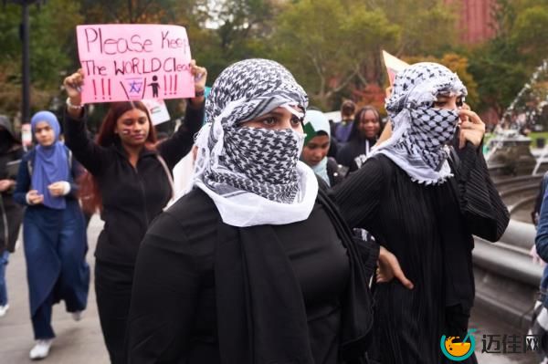 Ama Lou among a group of students, possibly from Urban Assembly Institute, participating in pro-Palestinian walkout at Washington Square Park, New York, holding anti-Israel posters