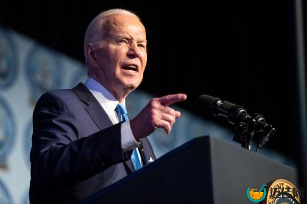 President Joe Biden speaking at a microphone during the 69th annual Fight for Freedom Fund Dinner in Detroit