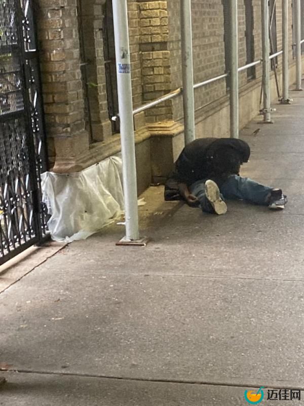 A photo of a person folded over on Walton Avenue after using drugs.