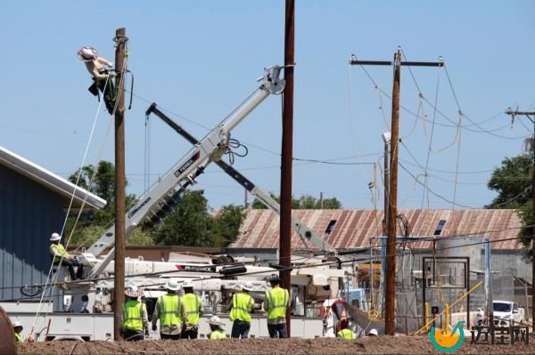 Power restoration and cleanup efforts in destroyed part of town.