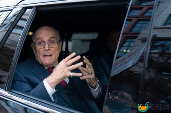 Former Mayor of New York Rudy Giuliani talks to reporters as he leaves after his defamation trial in Washington, Friday, Dec. 15, 2023