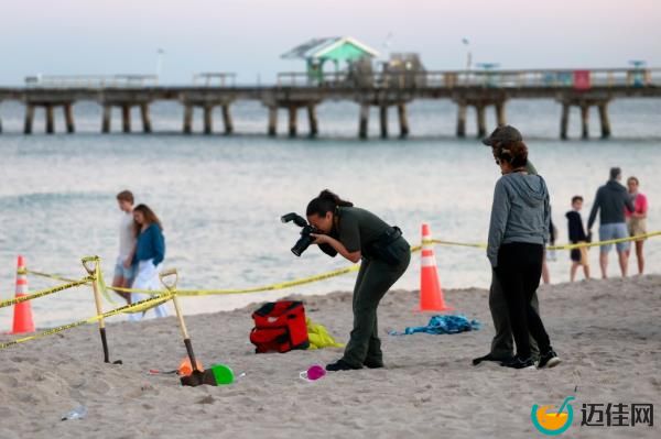Investigator takes photo of the sand hole 