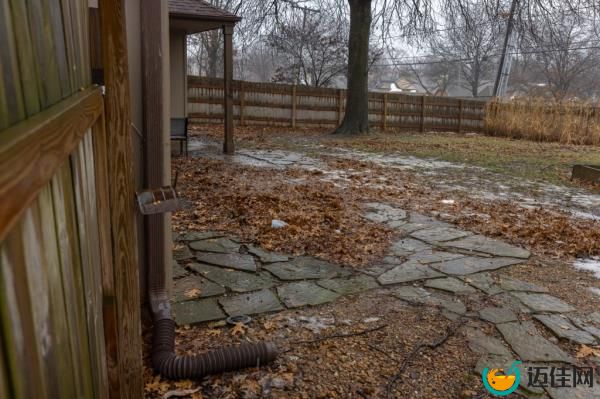 The house and back yard surrounded by a fence in The Coves in Kansas City, MO wher<em></em>e three friends were found deceased.
