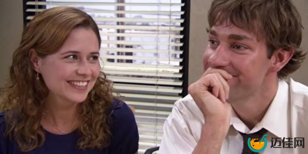 Pam and Jim giggling and smiling together on The Office